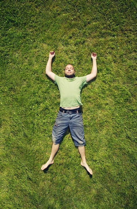 Man Lying On Grass In Summer Stock Photo