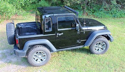 A Black Jeep Is Parked In The Grass