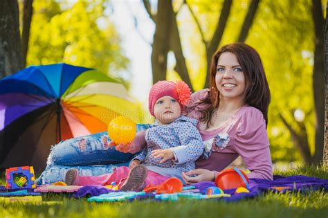 Happy Baby And Mom Are Playing In The Green Park Stock Photo Image Of
