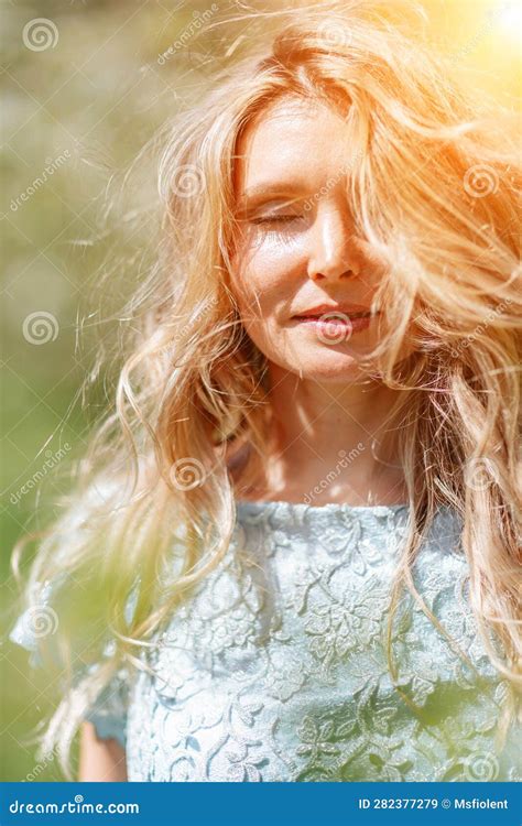 Blond Garden Portrait Of A Blonde In The Park Happy Woman With Long Blond Hair In A Blue Dress
