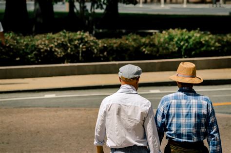 Two Men Wearing Cap And Hat Photo Free Apparel Image On Unsplash