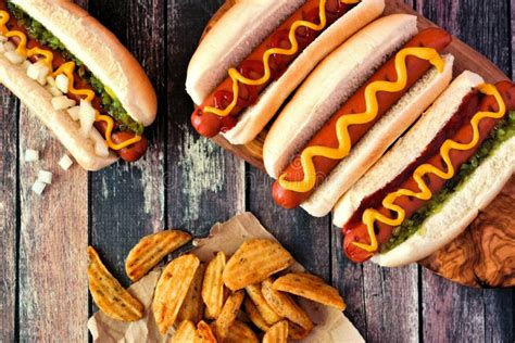 Hot Dogs With Potato Wedges Top View Table Scene Against Dark Wood
