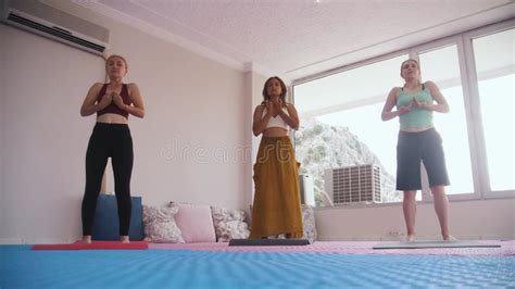 Yoga Class Three Women Do Yoga In A Bright Studio In Daylight Stock