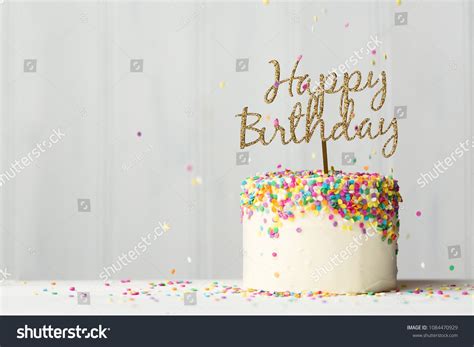 Colorful Birthday Cake With Golden Happy Birthday Banner And Falling