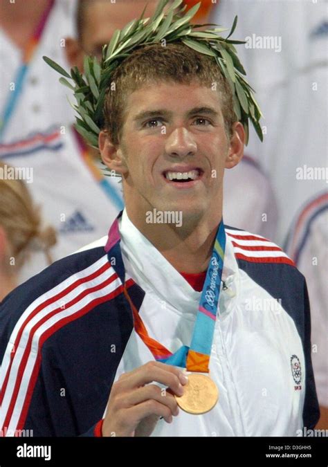 dpa us swimmer michael phelps shows the gold medal he won in the men s 200m butterfly at the