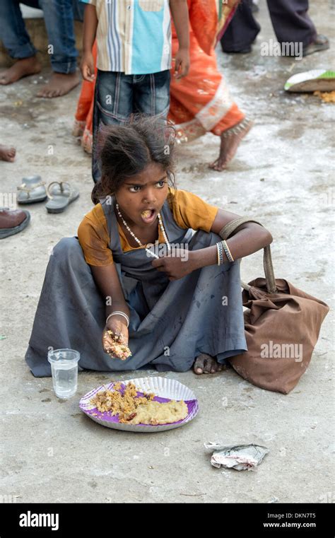 Poor Indian Lower Caste Girl Eating Free Food On An Indian Street