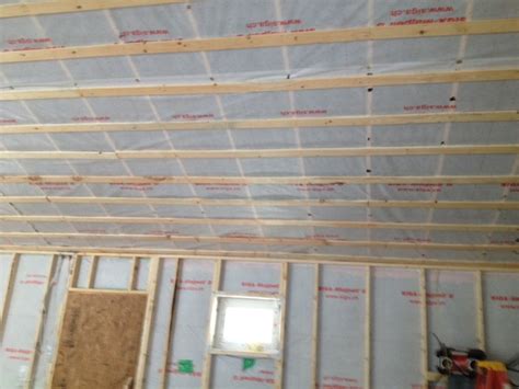 Suspended acoustic panel ceilings are not attractive and finished drywalled ceilings are not accessible. Insulating ceiling during winter construction ...