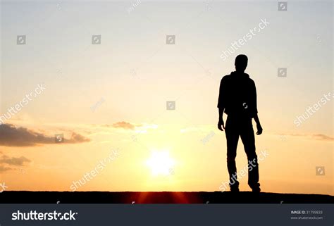 Silhouette Of A Lonely Man In The Sunset Stock Photo 31799833