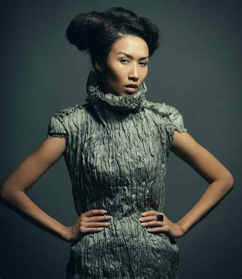 Studio Portrait Of Beautiful Woman In Grey Dress With Fashion Hairstyle