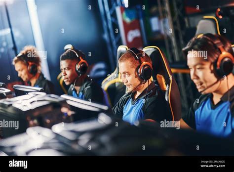 Team Of Four Professional Cybersport Gamers Wearing Headphones