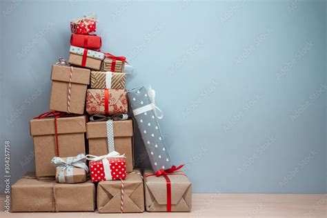 Pile Of Wrapped Christmas Ts On Blue Background Stock Photo Adobe