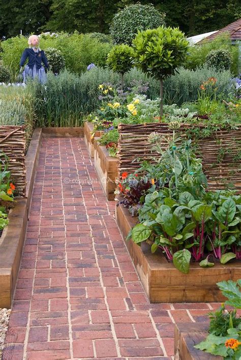 Brick Path Through Beautiful Raised Bed Vegetable Gardens