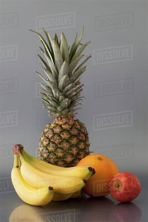 Pineapple Bananas Orange And Apple Stock Photo Dissolve