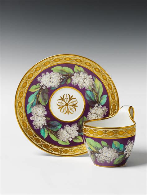 A Berlin Kpm Porcelain Cup And Saucer With Lilac Flower And Gilt Relief