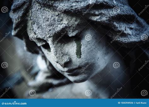 Ancient Stone Statue Of Crying Sad Angel With Tears In Face As Symbol
