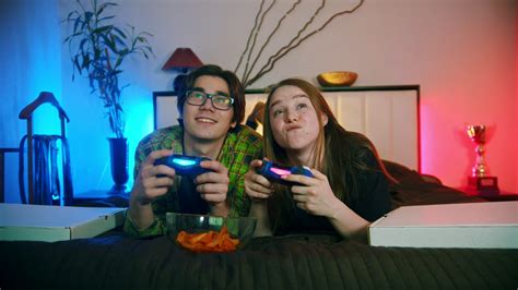 I was trying to name pairs of tarantulas. Young couple playing video games on the bed - Free Stock Video