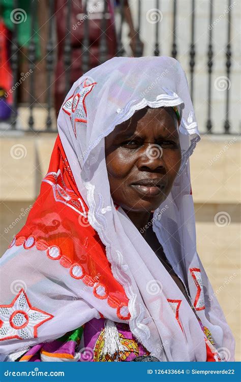 Unidentified Senegalese Woman In Colored Traditional Clothes Wa