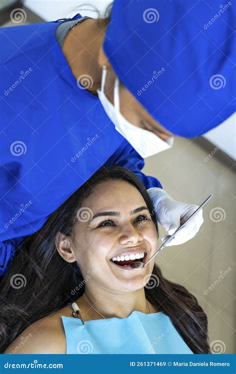 Beautiful Patient Smiling At Her Dentist In Dental Office Stock Image