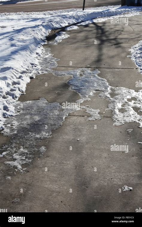 Icy Patches On A Sidewalk Stock Photo Alamy