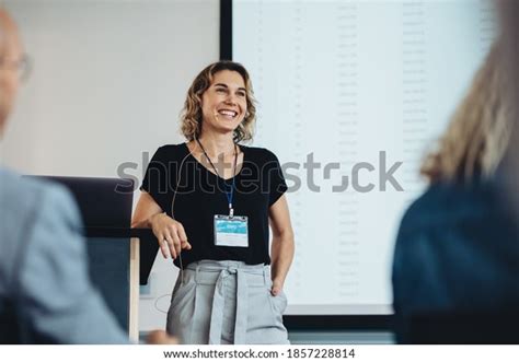 Smiling Businesswoman Delivering Speech During Conference Stock Photo