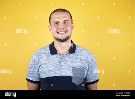 Russian Man Standing Over Insolated Yellow Background With A Happy And