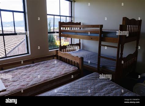 Four Beds In A Cramped Bedroom Stock Photo Alamy