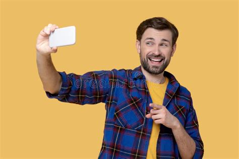 Cheerful Grimacing Man Taking A Selfie On A Smartphone Stock Image