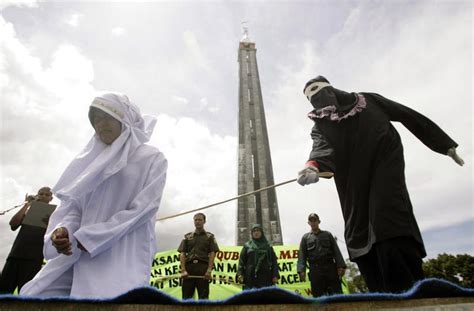 Indonesias Aceh Authorities Lash Hundreds Under Sharia Statutes
