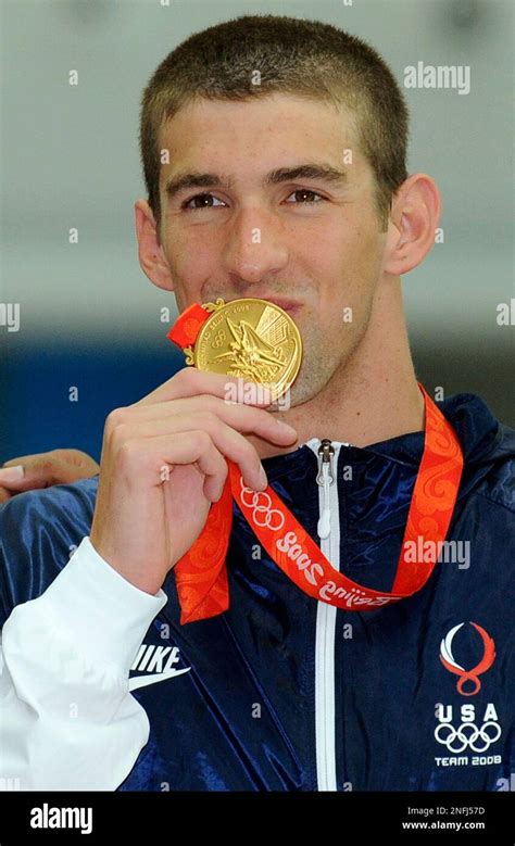 United States Michael Phelps Kisses His Gold Medal At The Medal Ceremony For The Mens 4x100