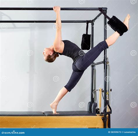 Pilates Woman In Cadillac Split Legs Stretch Exercise Stock Image
