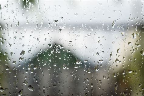 Raindrops On Window Pane Blurred Background Outside The Window In The