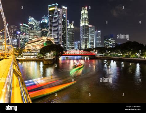 Light Trails Of Tour Boat On The Singapore River With The Skyscraper Of