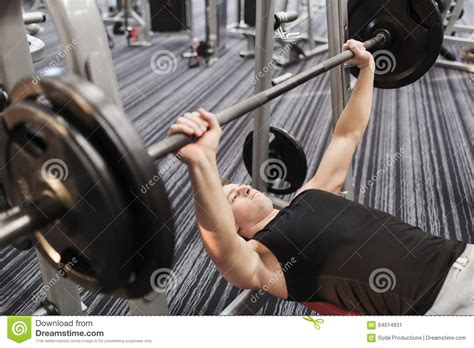 Young Man Flexing Muscles With Barbell In Gym Stock Image Image Of