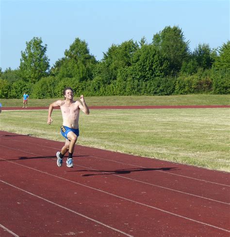 Fitness Man Sprinting On The Field Track