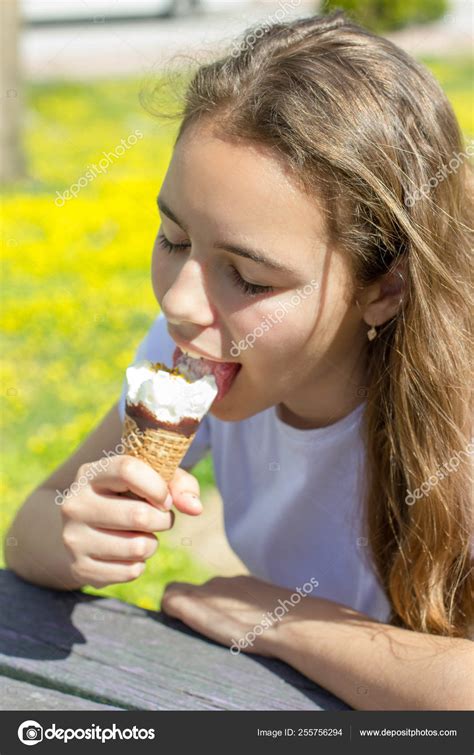 Beautiful Teen Girl Eating Ice Cream In A Waffle Cone In Summer