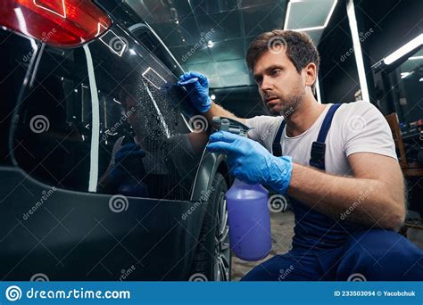 Car Repairman Sprinkling Car Surface With Liquid Stock Photo Image Of
