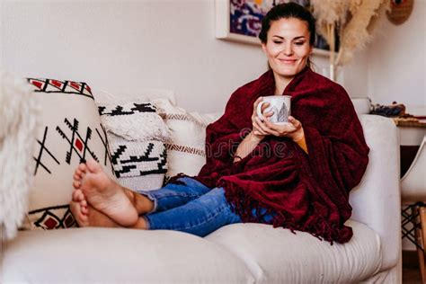 Beautiful Woman Sitting On The Sofa Enjoying A Cup Of Tea Lifestyle