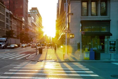 Sunset On The Corner Of 23rd Street And 5th Avenue With People And Cars