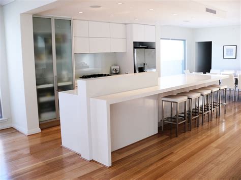 The slated shelves in this kitchen have butchers hooks hanging from them, doubling up the storage. Artra Custom kitchens and Commercial Cabinets Perth | Artra