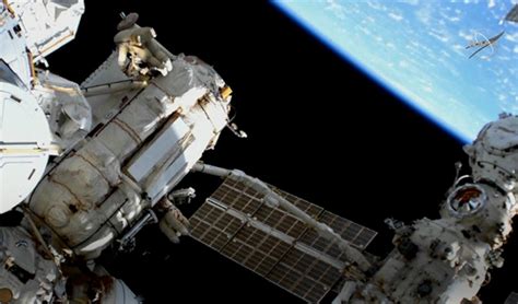 russian cosmonauts return to the international space station after the first spacewalk of the