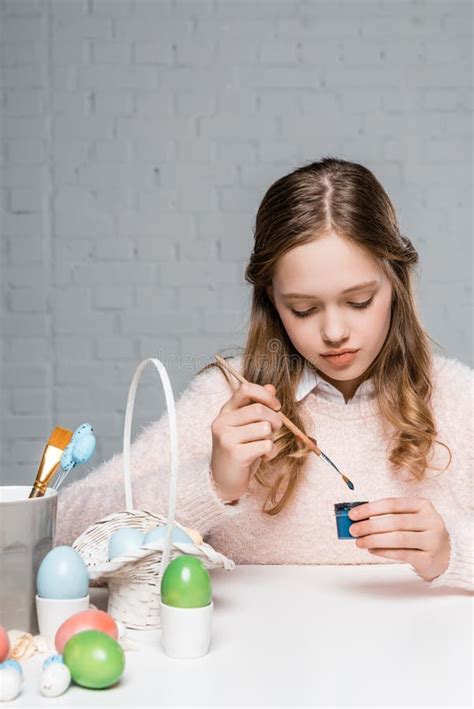 Little Girl Painting Easter Eggs At Table Stock Photo Image Of