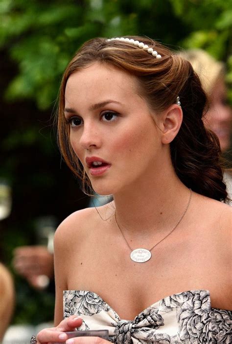 a woman in a strapless dress with a necklace on her neck and an earring