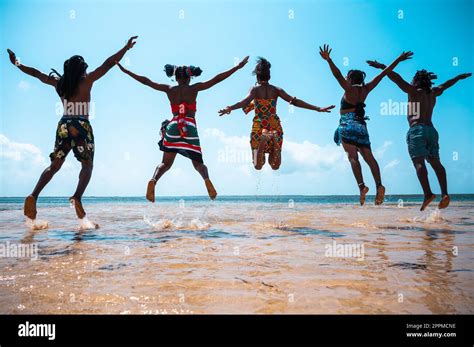 Kenyan People Jump On The Beach With Typical Local Clothes Stock Photo