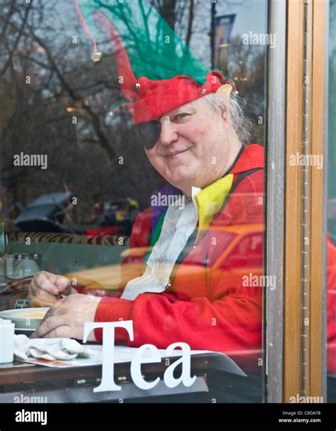 Santa Claus Elf Helper Eating Lunch In Nyc Restaurant Window During