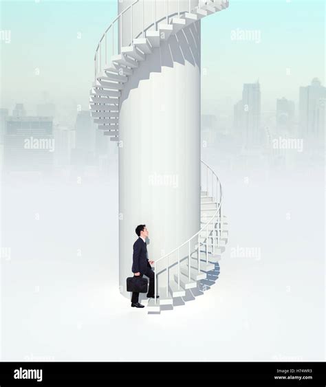 Business Man Going Upstairs In A Curved Staircase To Success Stock