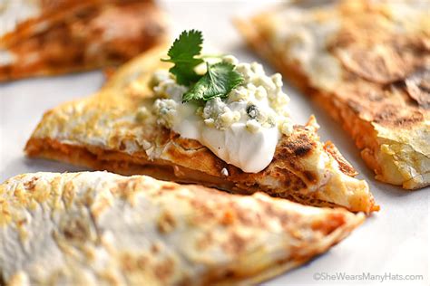 Part quesadilla, part crisp tostada, this chicken tinga dish is the ultimate party food. Buffalo Chicken Quesadillas Recipe | She Wears Many Hats