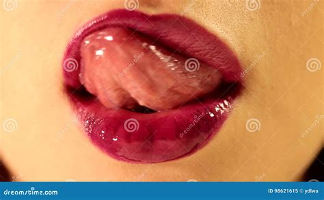 Beautiful Female Tongue Licking Her Lips With Bright Deep Red Plum