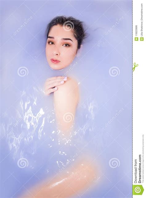 Naked Woman In A Bath With Purp Water Spa And Wellness