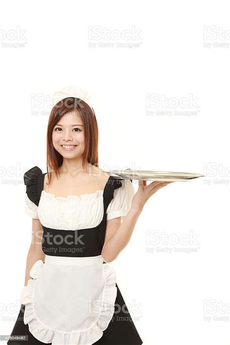 Young Japanese Woman Wearing French Maid Costume With Tray Stock Photo