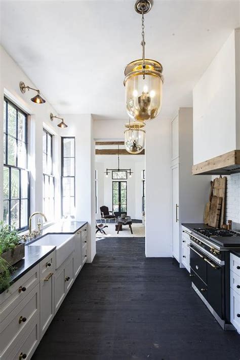 Check out this easy diy painted osb floors tutorial! Black and White Galley Style Kitchen with Mercury Glass ...
